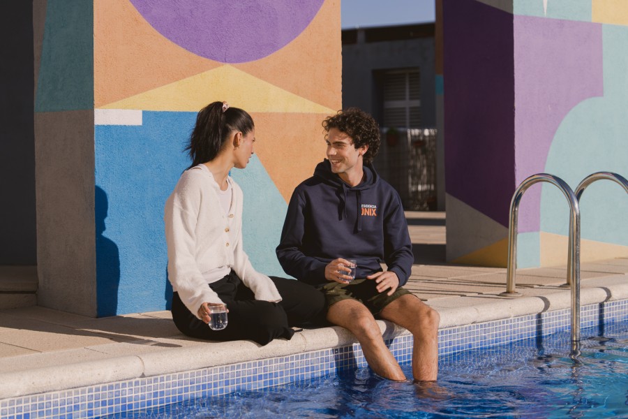 Students relaxing by the pool at ONIX student accommodation in Barcelona